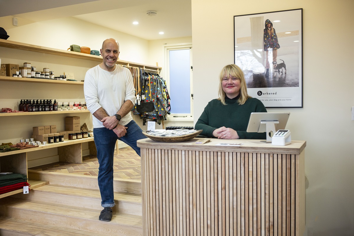 Shop owners in Kent standing in their shop smiling