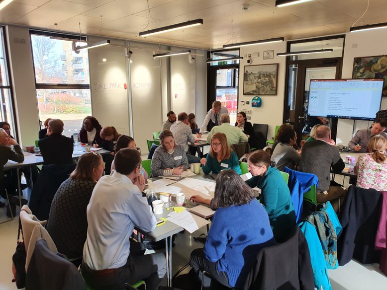 Group of collaborators in a meeting room in roundtables 