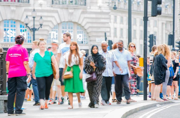 crowd of people walking in city street