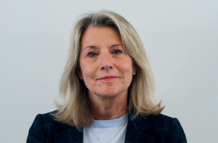 Debbie Ward a blonde lady looks towards the camera