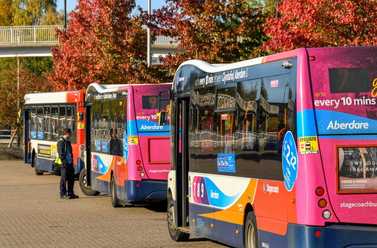 Row of parked single decker buses