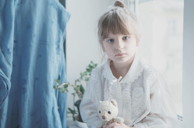 Young girl holding a teddy bear