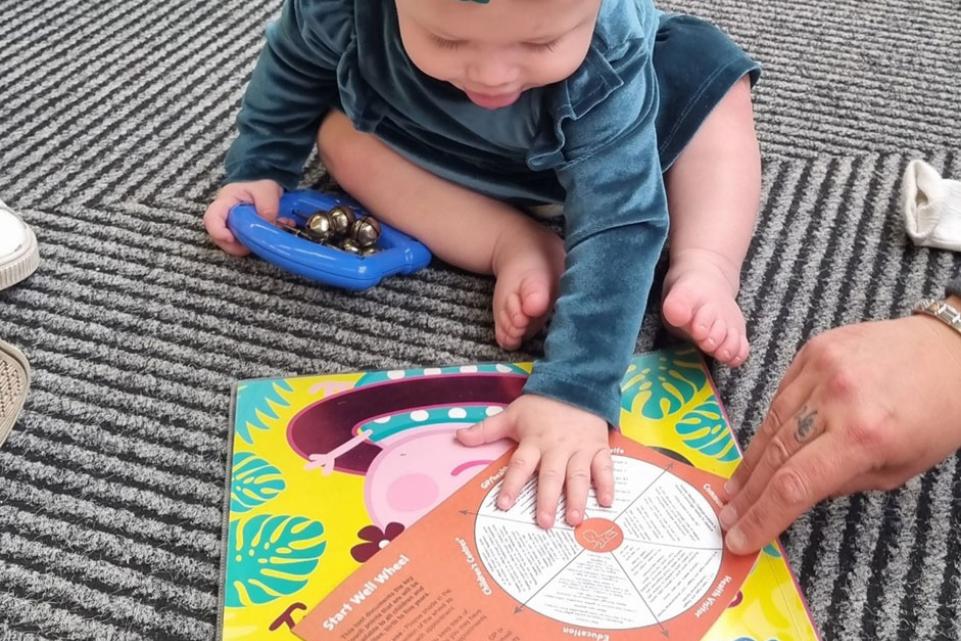 Harper with the Start Well Wheel at Parr Library Read and Rhyme Time